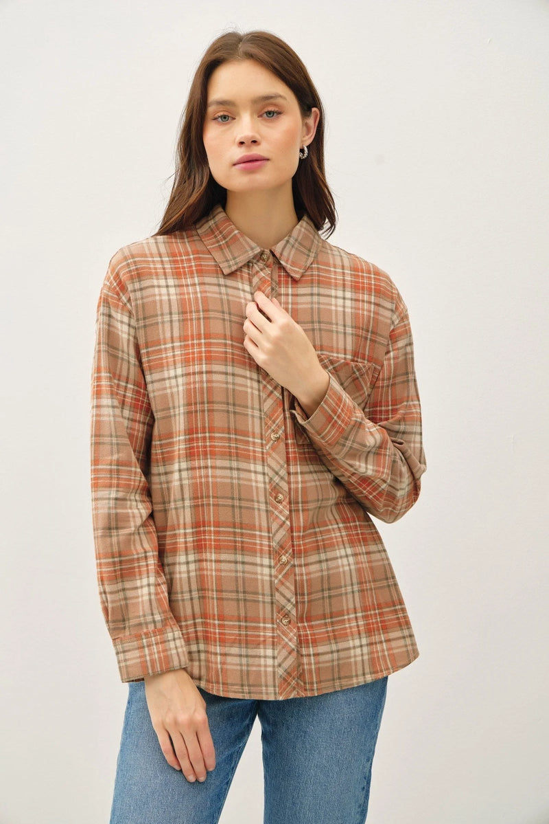 Plaid button-up shirt in warm autumn colors, featuring oversized cotton flannel design