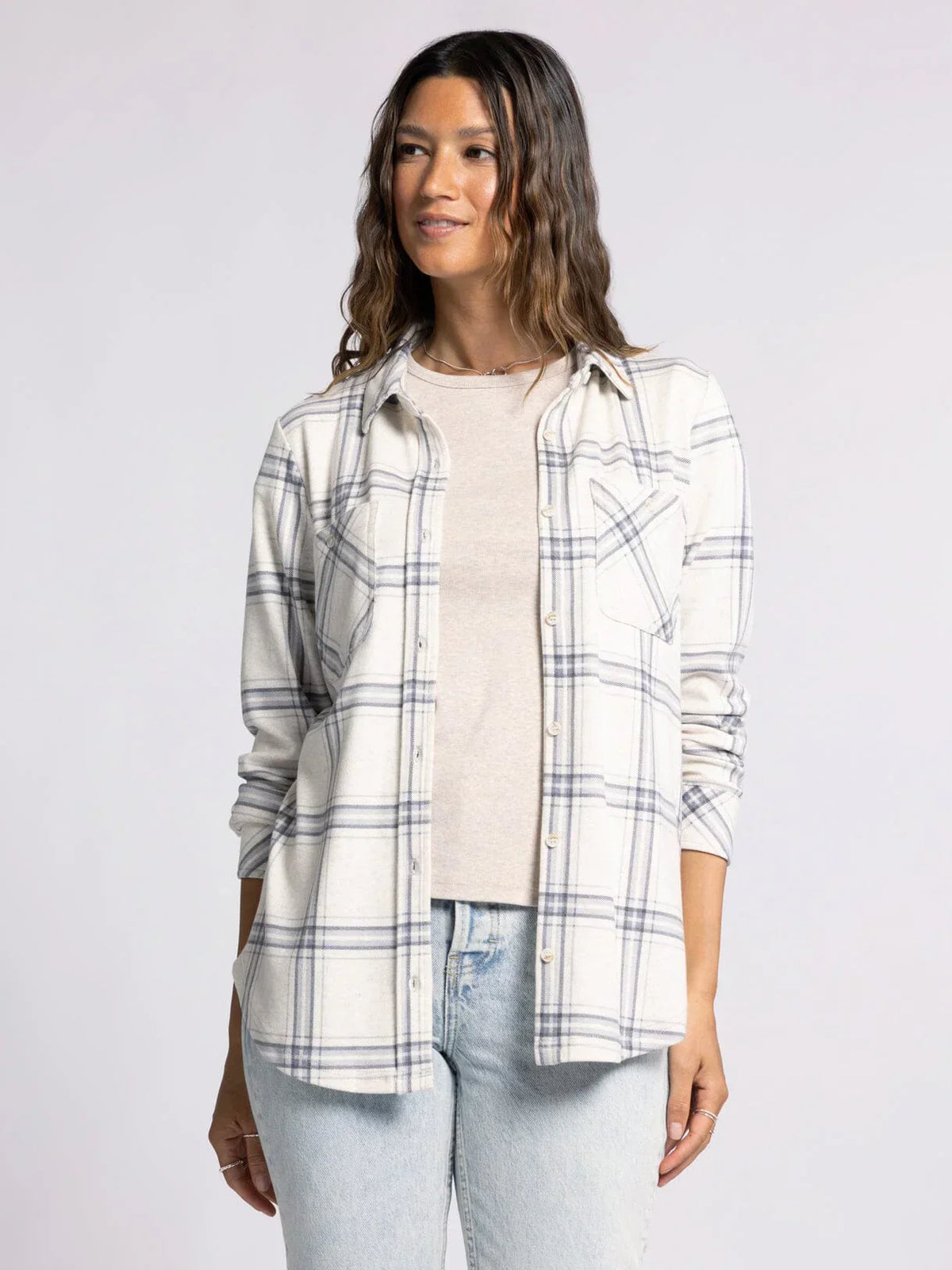 Plaid collared button-up shirt over white top paired with light jeans in Plush Collared Button Down Top