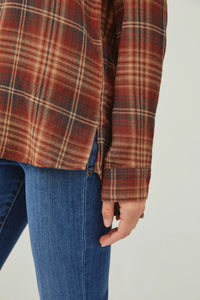 Classic button down flannel shirt with side slit, styled over blue jeans