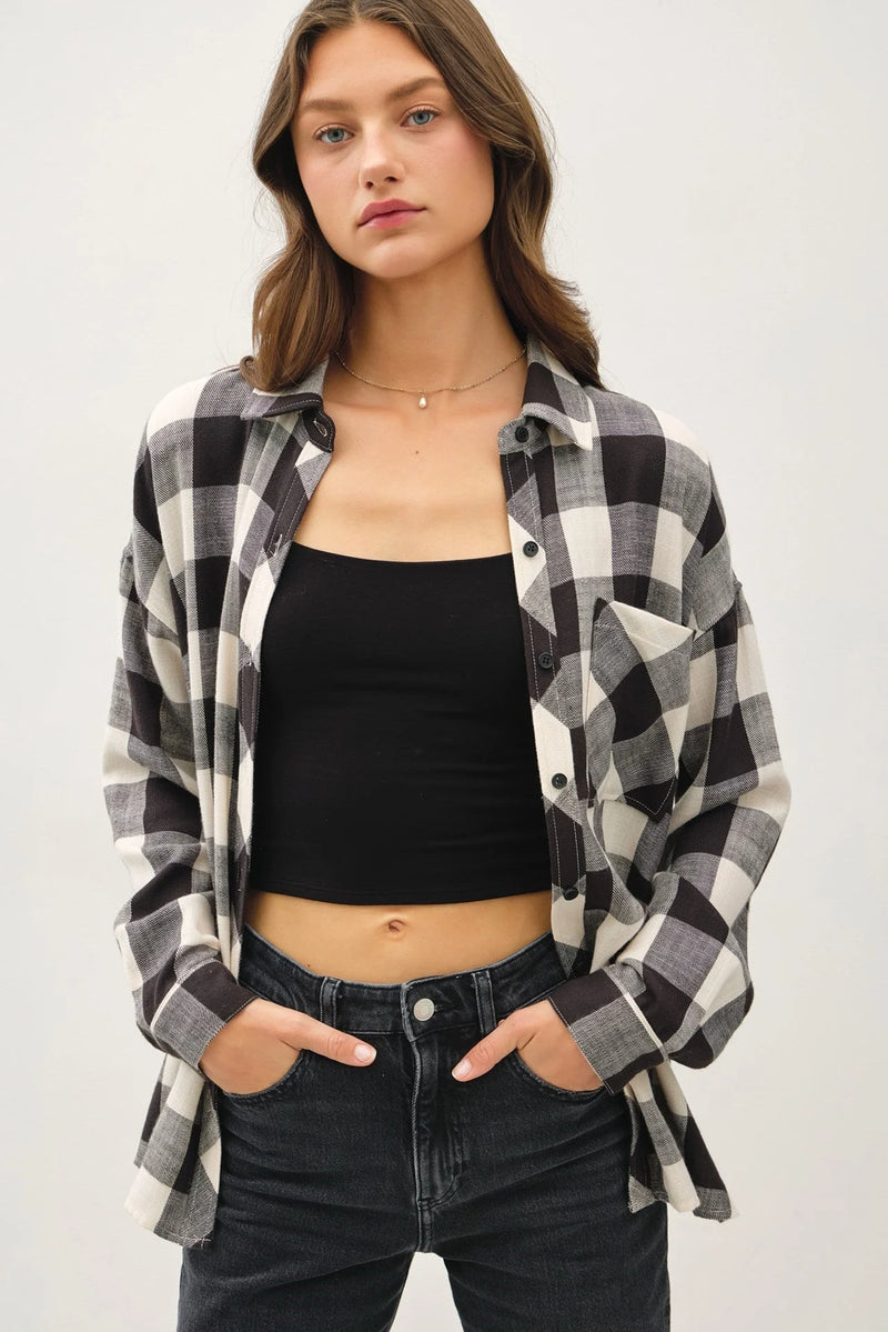 Plaid flannel shirt styled open over black crop top and jeans in soft buffalo check design