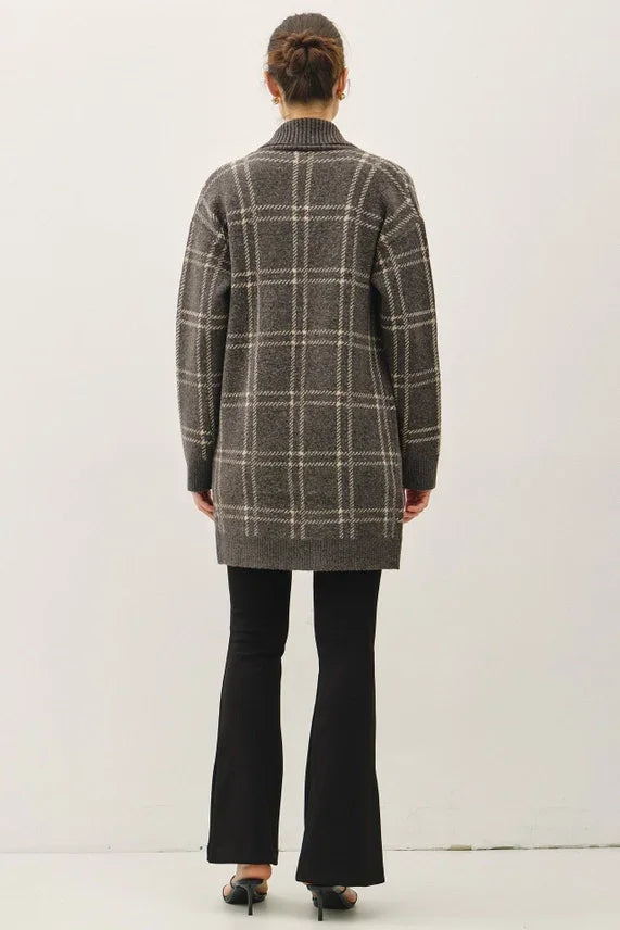 Plaid jacquard open coatigan with black flared pants and bun hairstyle