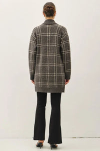 Plaid jacquard open coatigan with black flared pants and bun hairstyle