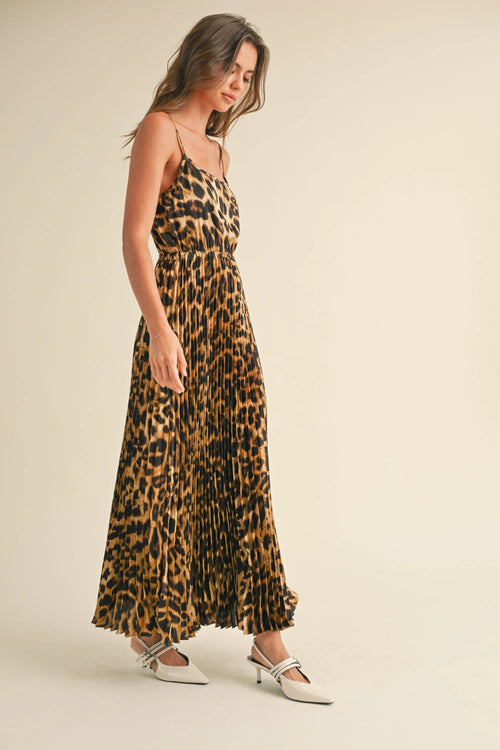 Leopard print pleated dress with spaghetti straps and elegant flowing design