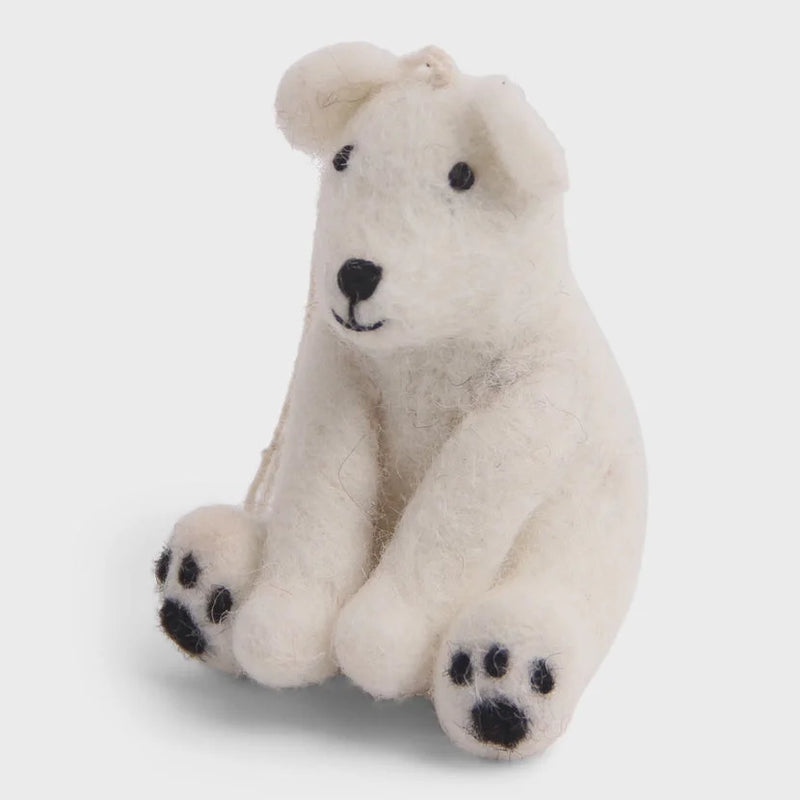 Handmade polar bear sitting ornament with white fur, black paws, and nose