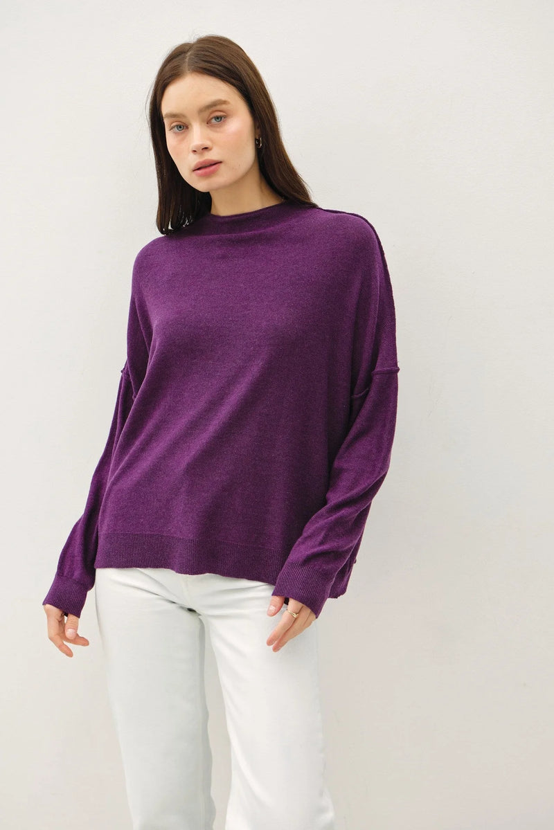 Purple oversized mock neck sweater with long sleeves and relaxed fit design