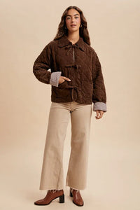 Garment washed quilted corduroy jacket with toggle closures and checkered cuff lining