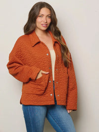 Quilted orange jacket with collar and pockets over white top and blue jeans from Shop Daisy