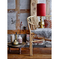 Rattan chair with curved back slats complements Square Stonewashed Linen Fringe Rust Pillow