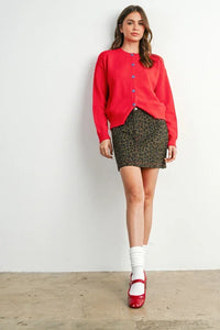 Red button-up cardigan with blue buttons, perfect for leopard print mini skirt and women’s boho chic clothing
