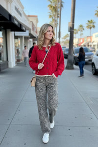 Red cable cardigan with leopard pants and white sneakers, boho chic style