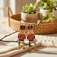 Festive jeweled nutcracker dangle earrings with red green toy soldiers and pearls