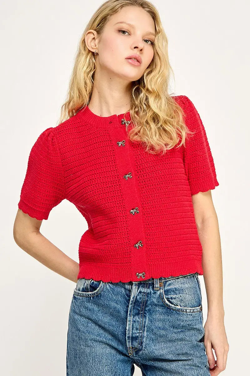 Red knit cardigan with decorative buttons from Shop Daisy, perfect for women’s boho chic clothing