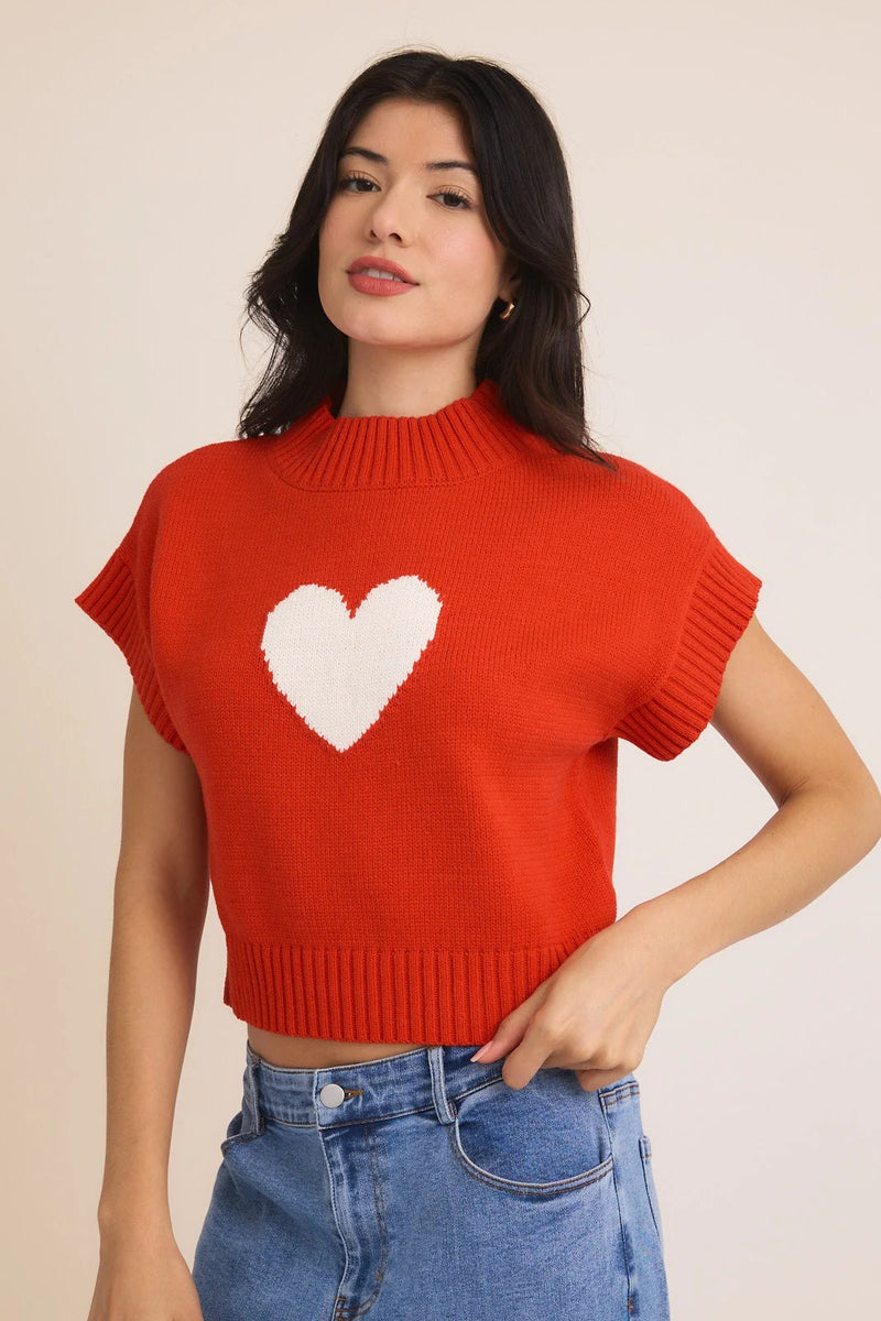 Red knit crop top featuring a white heart design, ideal for a Mock Neck Wide Shoulder Heart Sweater