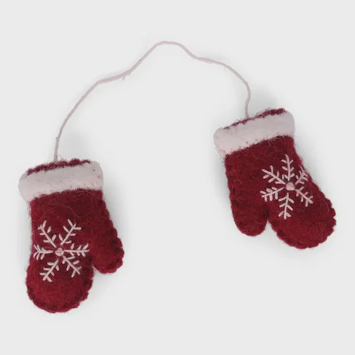 Red handmade mittens ornament with snowflake design, white trim, and hanging cord