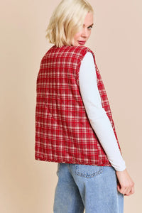 Red plaid quilted vest jacket over white top and blue jeans in women’s boho chic clothing