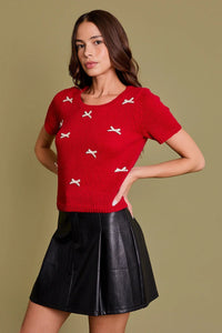 Red short-sleeved sweater with white bows from Shop Daisy, ideal for women’s boho chic clothing