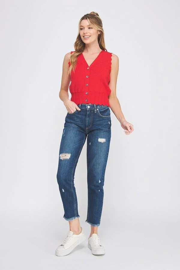 Red sleeveless button-up vest paired with distressed jeans and white sneakers, featuring pointelle knit