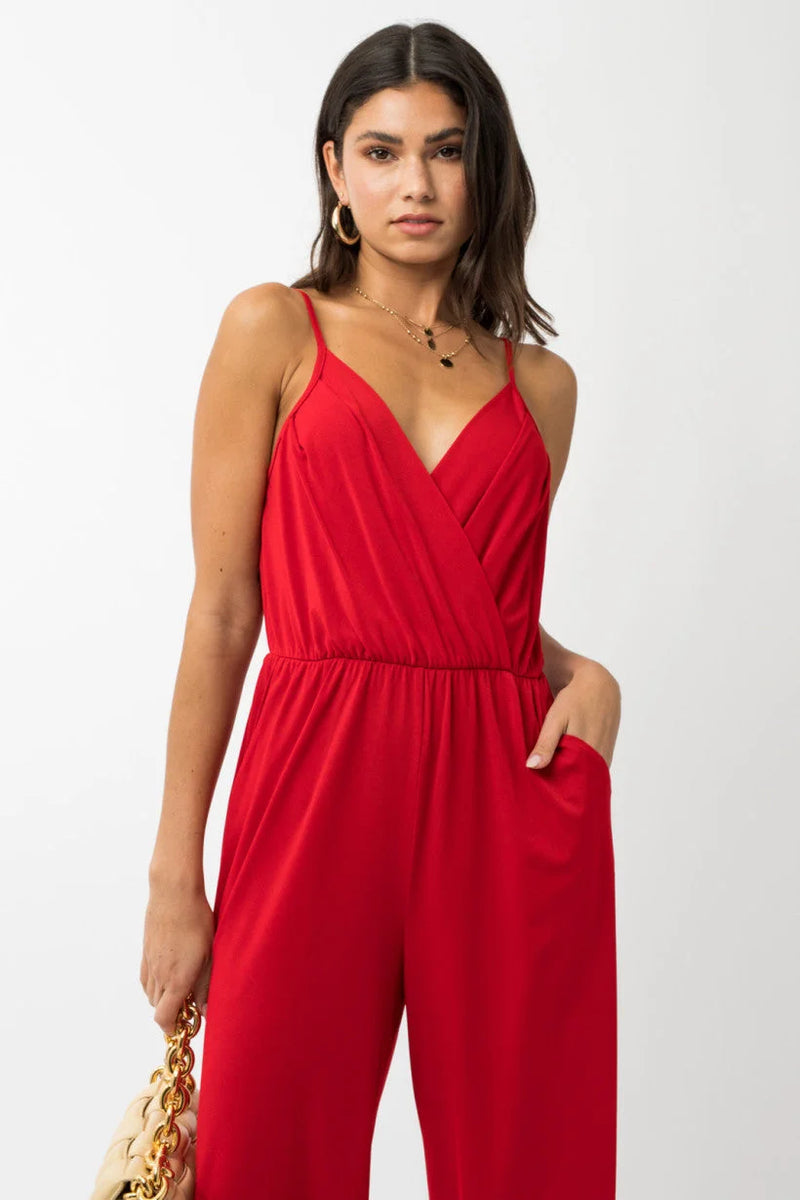 Red sleeveless cropped jumpsuit featuring a wrap-style top and wide-leg pants from Shop Daisy