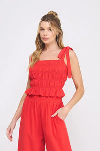 Red soft linen smocked tank top with tie straps featuring smocked tie details