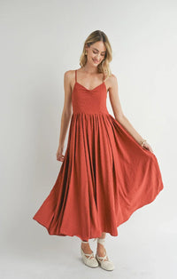 Flowing red sundress with spaghetti straps, a full skirt, and collectible sweetheart neckline