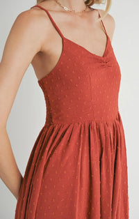 Red sundress with dots and thin straps, showcasing a collectible sweetheart neckline