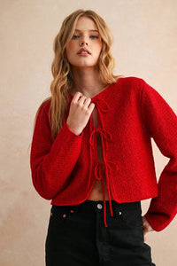 Red textured long sleeve cardigan with lace-up front and bell sleeves