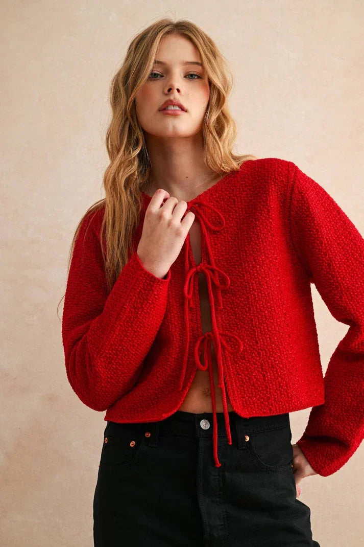 Red textured long sleeve cardigan with lace-up front and bell sleeves