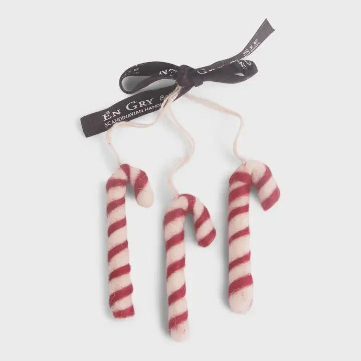 Handmade candy cane ornament with red white stripes fuzzy texture black ribbon
