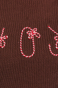 Red and white candy cane decorations on brown fabric for Turtle Neck Sleeveless Cropped Joy Top