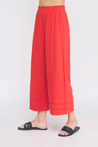 Red elastic ruffle waist ankle pants displayed in ELASTIC RUFFLE WAIST ANKLE PANTS product
