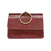 Reddish-brown leather clutch with brass ring handle showcasing widest point and interior zip in ARIA RING BAG