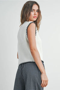 Solid cap sleeve sweater vest with ribbed cream knit and plaid pants for stylish layering