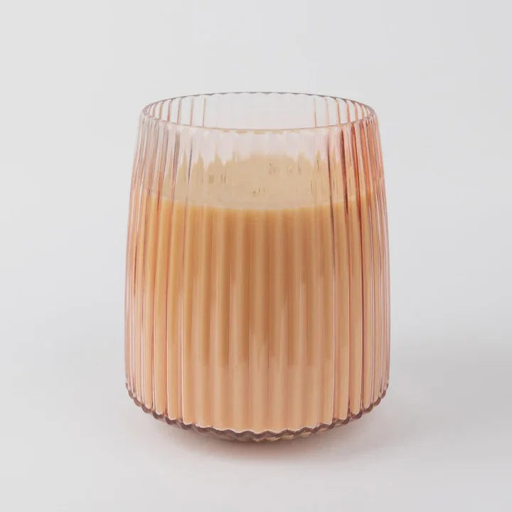 Ribbed glass tumbler with creamy orange sparkling tea in Sweet Grace Jumbo Candle