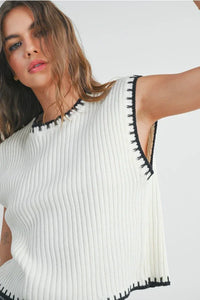 Solid cap sleeve sweater vest with ribbed knit and black whipstitch trim