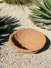 Decorative handmade paper mache bowl featuring a rock in the desert setting