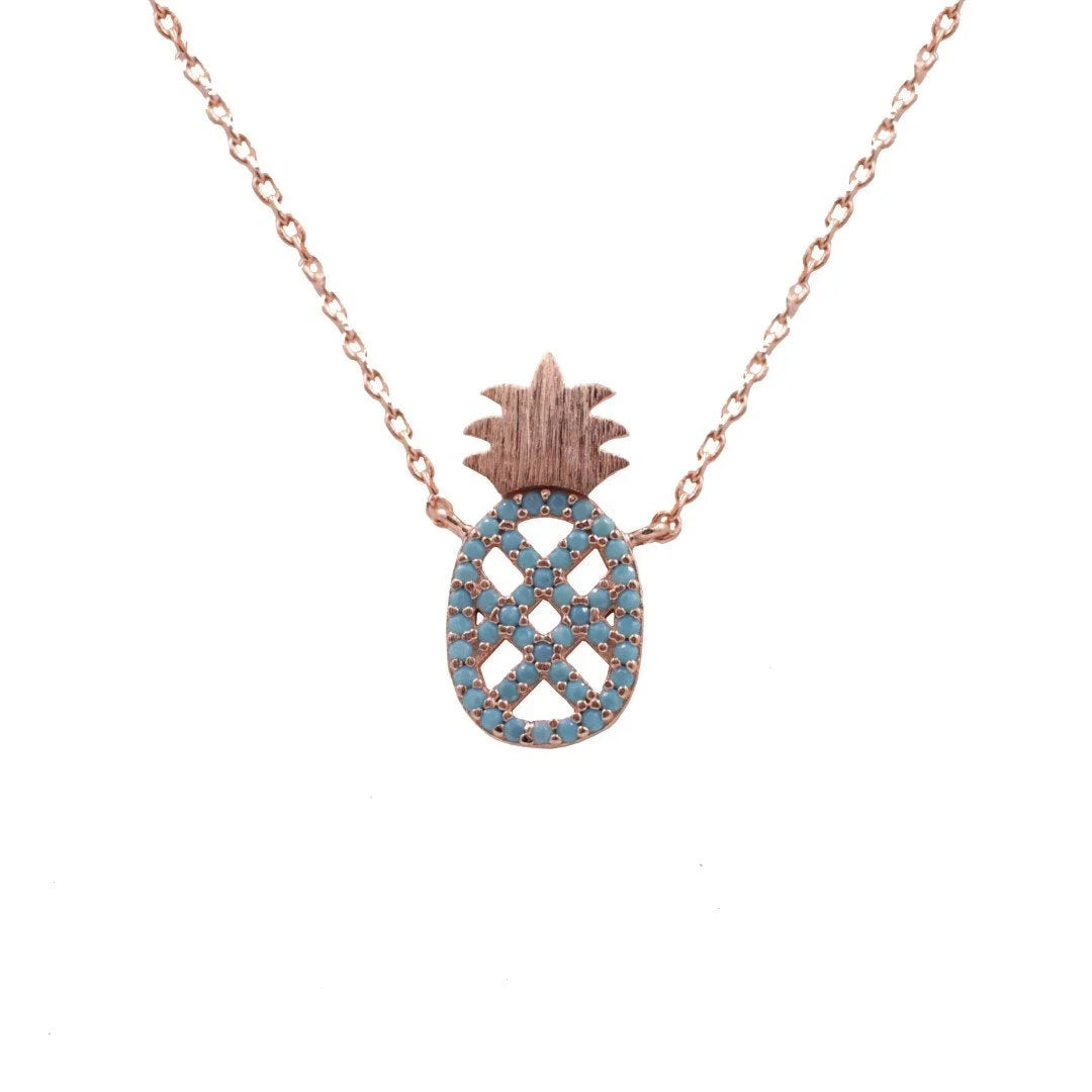 Rose gold necklace featuring a turquoise pineapple pendant with blue and white diamonds