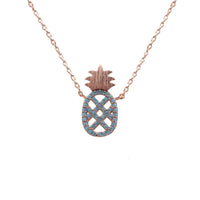 Rose gold necklace featuring a turquoise pineapple pendant with blue and white diamonds