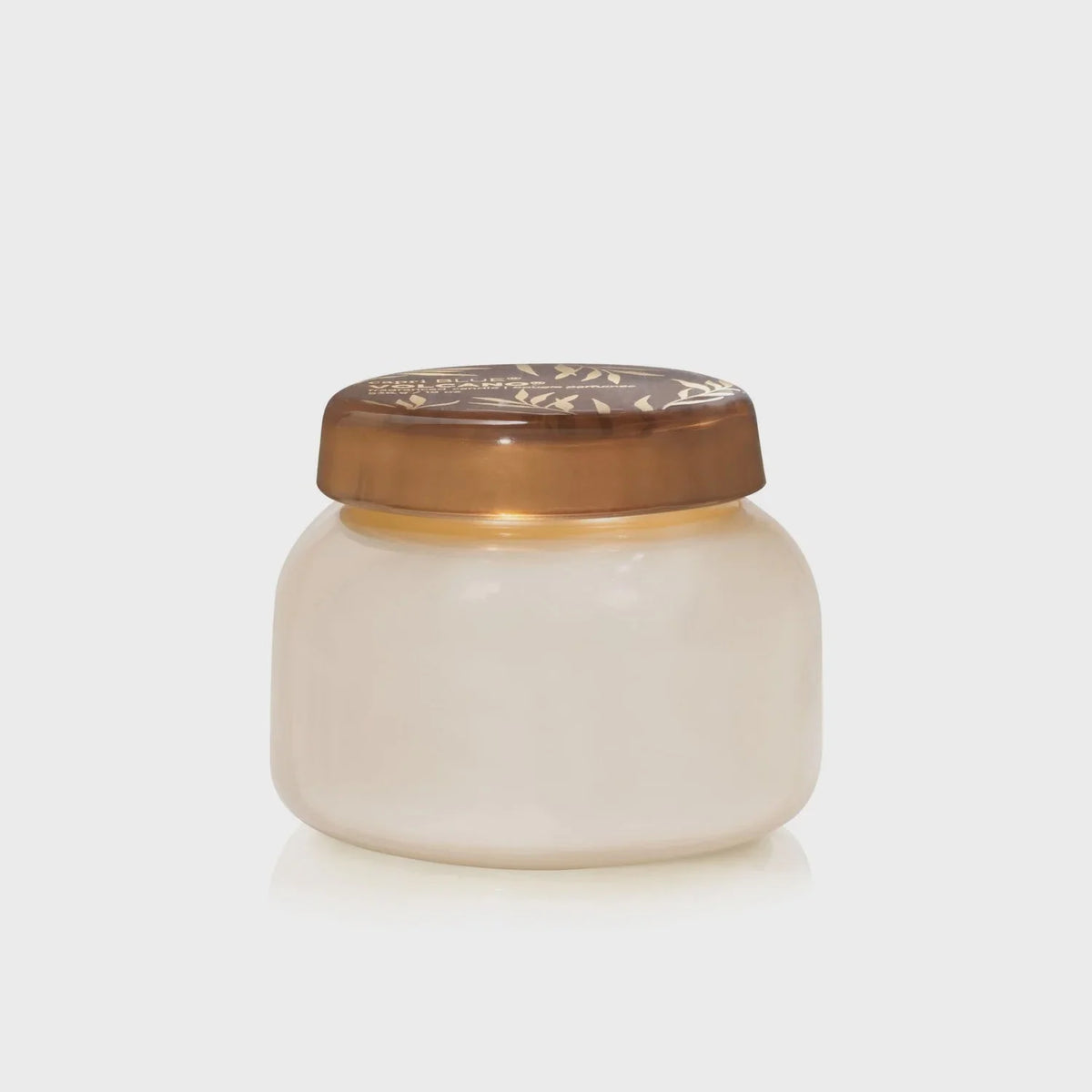 Small round jar of cream with decorative bronze lid from Capri Blue Volcano collection