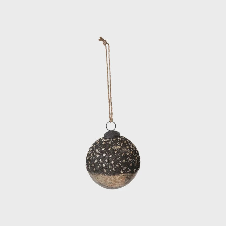 Round glass ball ornament with dark textured top and smooth metallic bottom, adorned with stars