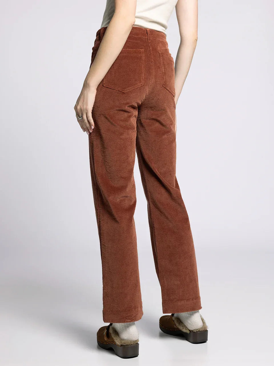 Rust-colored corduroy supply Gladys pants worn by a person showcasing the Gladys pants