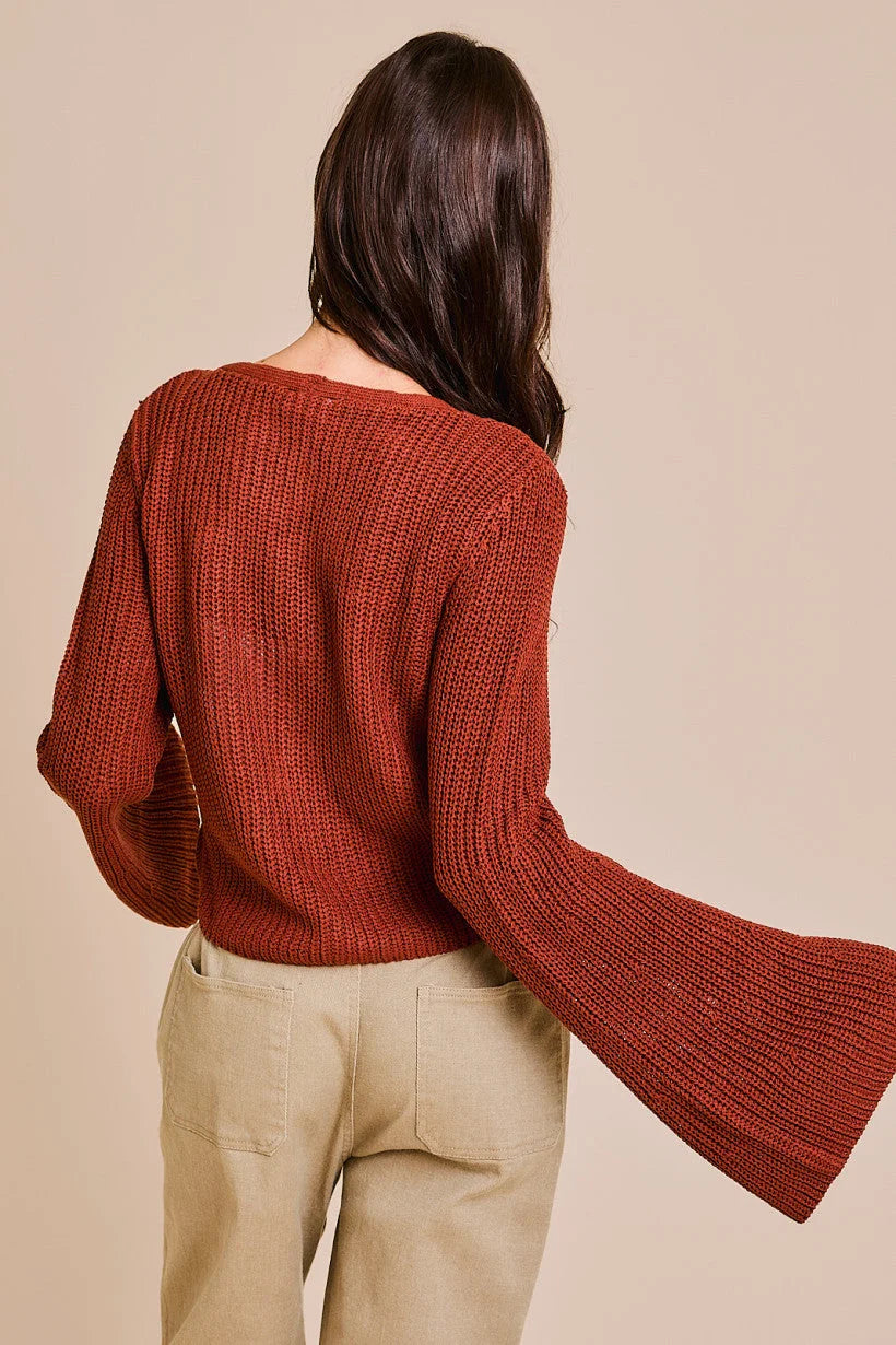 Rust-colored bell sleeve cardigan with wide sleeves, ideal for stylish layering