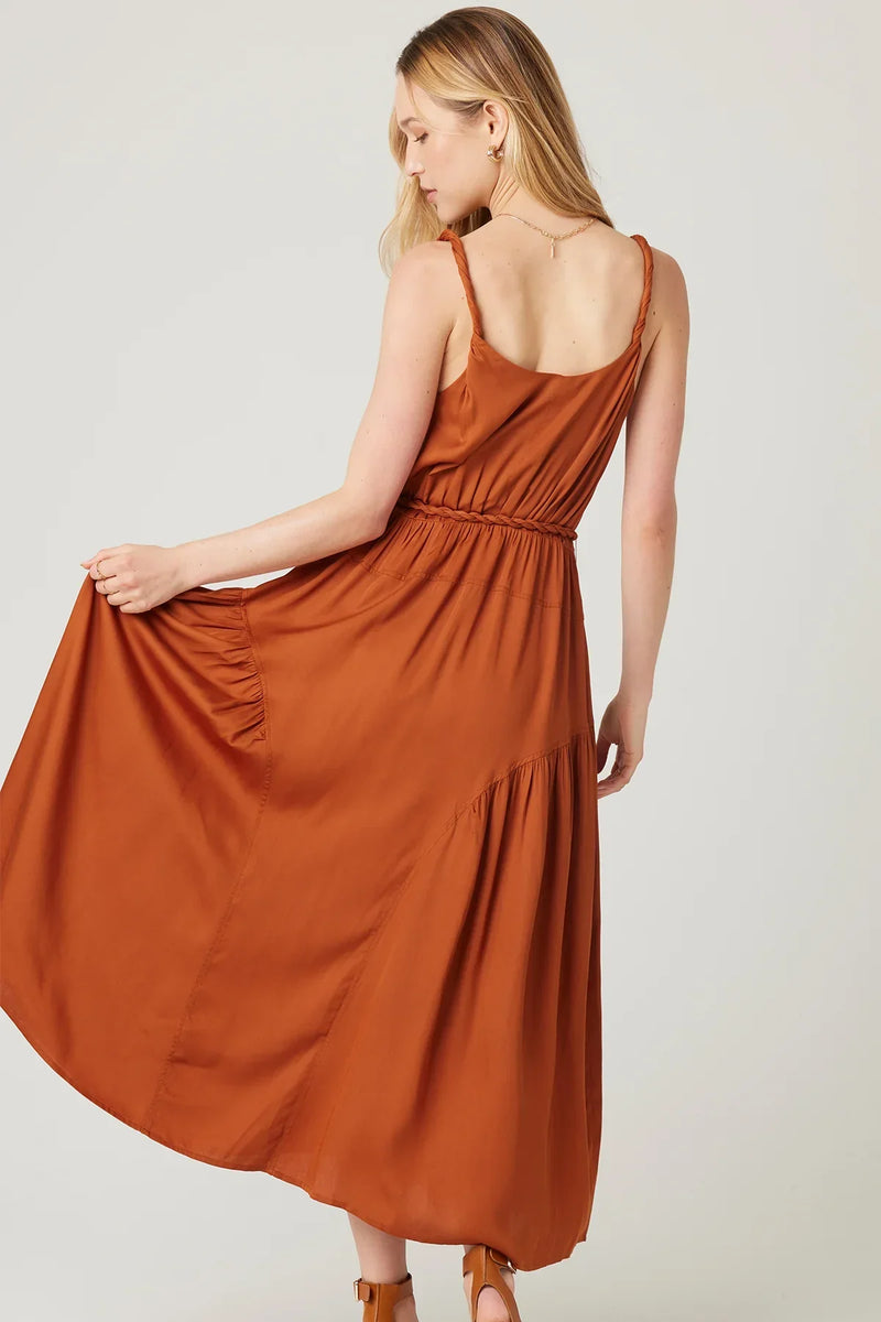 Rust-colored AURA MIDI DRESS featuring spaghetti straps and a flowy boho skirt