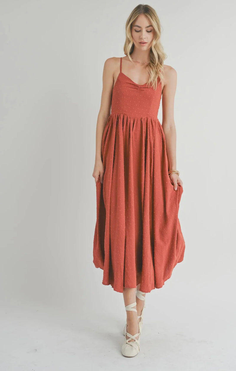 Rust-colored sleeveless maxi dress with spaghetti straps, a collectible sweetheart neckline