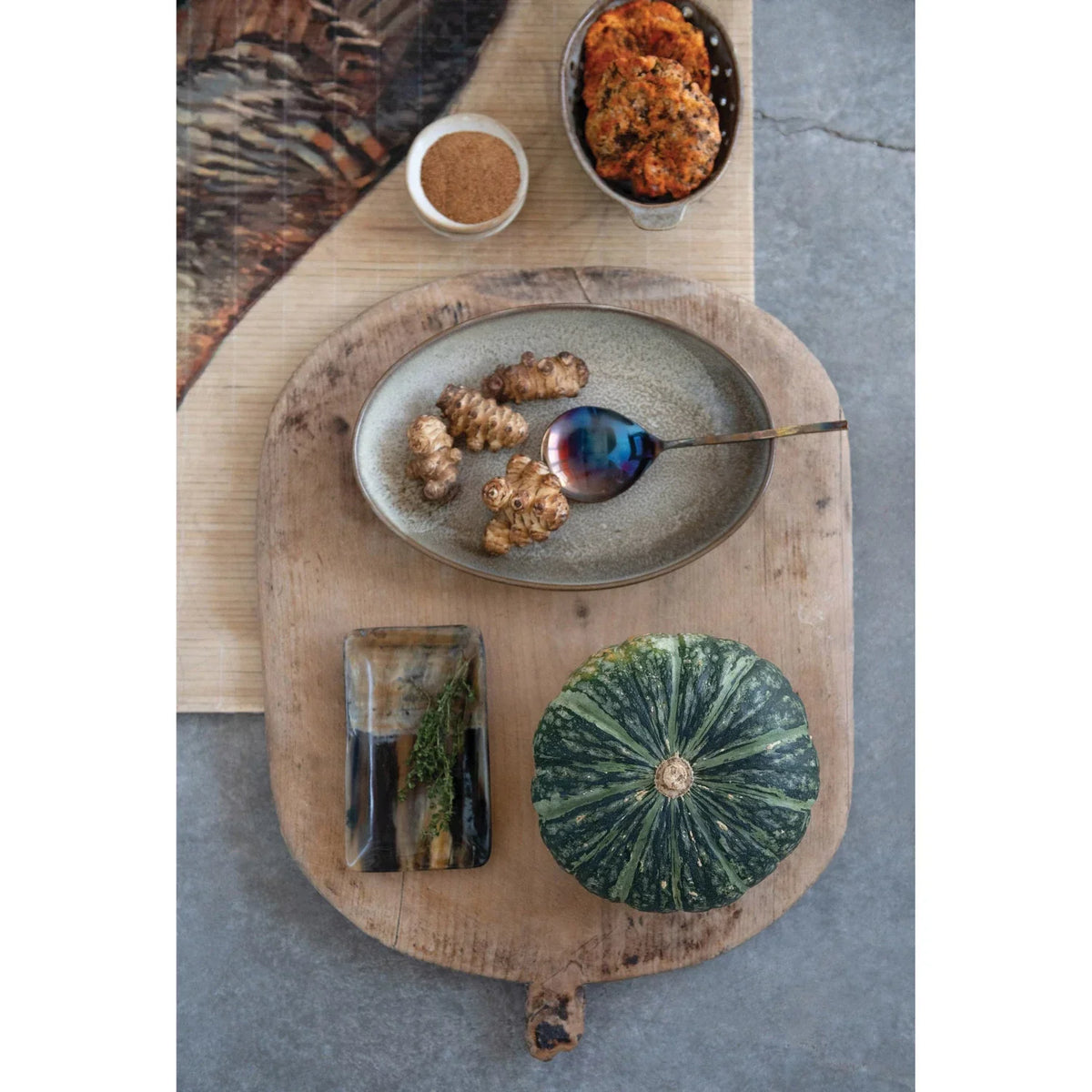 Rustic wooden paddle board displayed with a Stoneware Mini Bowl for elegant serving