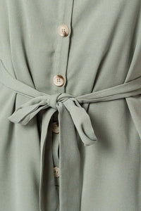 Sage green sleeveless button-down romper with fabric belt for a flowy boho look