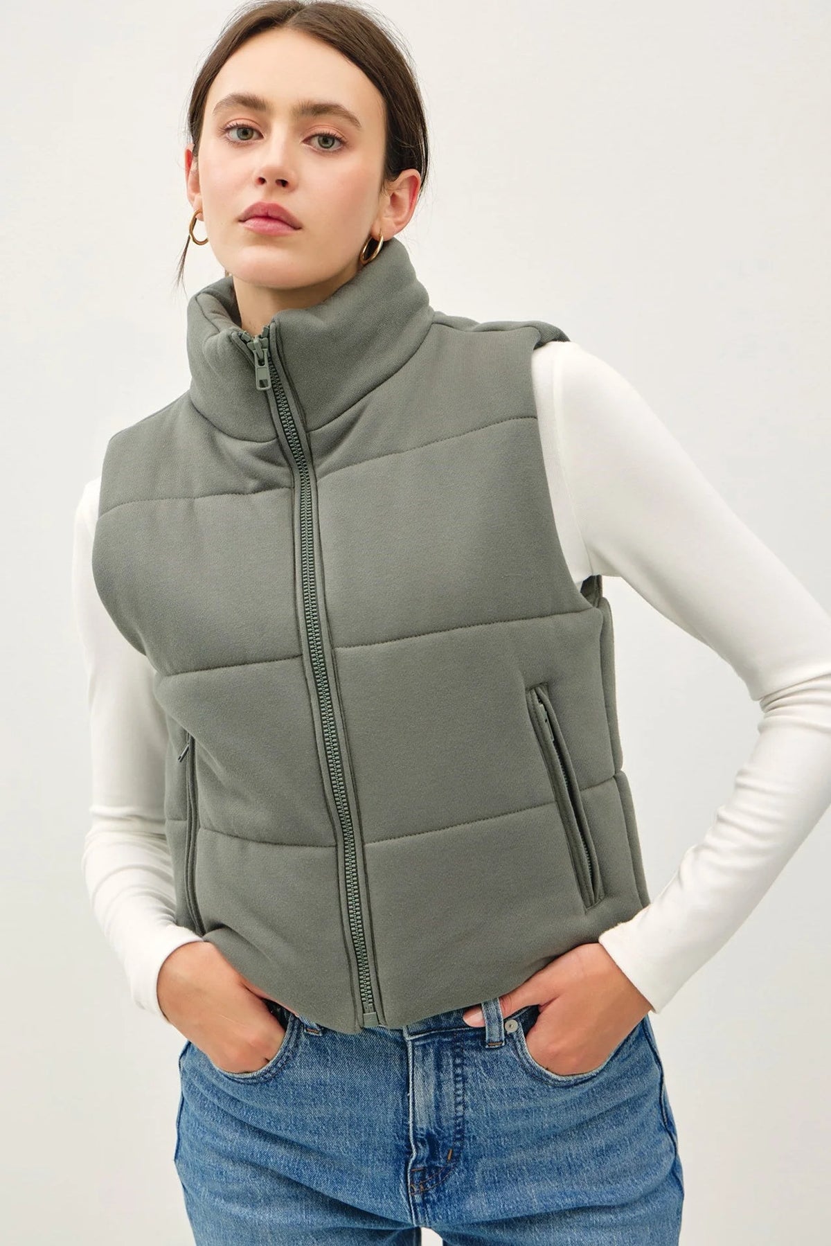 Sage green puffer vest with high collar and zipper closure for boho fashion styles