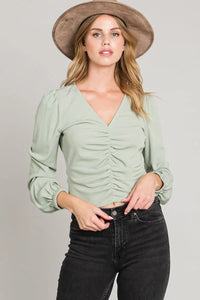 Sage green center ruched blouse with long sleeves and v-neckline for women’s boho chic clothing