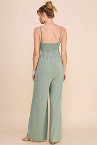 Sage green babydoll wide leg jumpsuit with spaghetti straps on a woman from behind