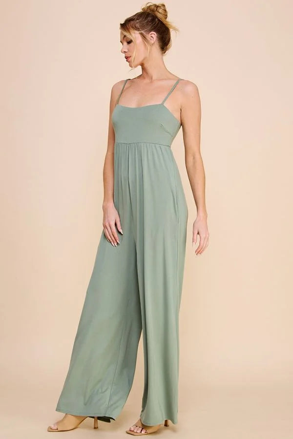 Sage green babydoll wide leg jumpsuit with spaghetti straps and an empire waist