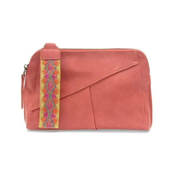 Salmon-colored vegan leather clutch featuring zip closure and woven wristlet strap